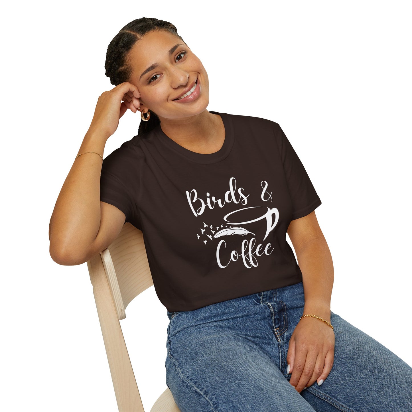 Woman wearing a brown t-shirt with 'Birds & Coffee' text, sitting on a chair.