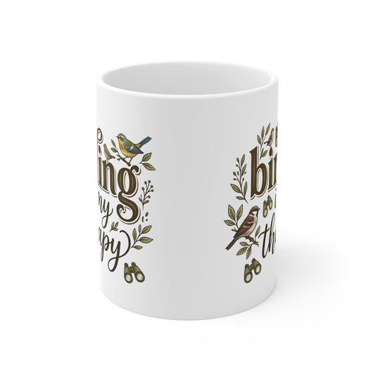 A white ceramic mug featuring a printed design with brown cursive text, green leaves, and small birds, shown on a clean white background.