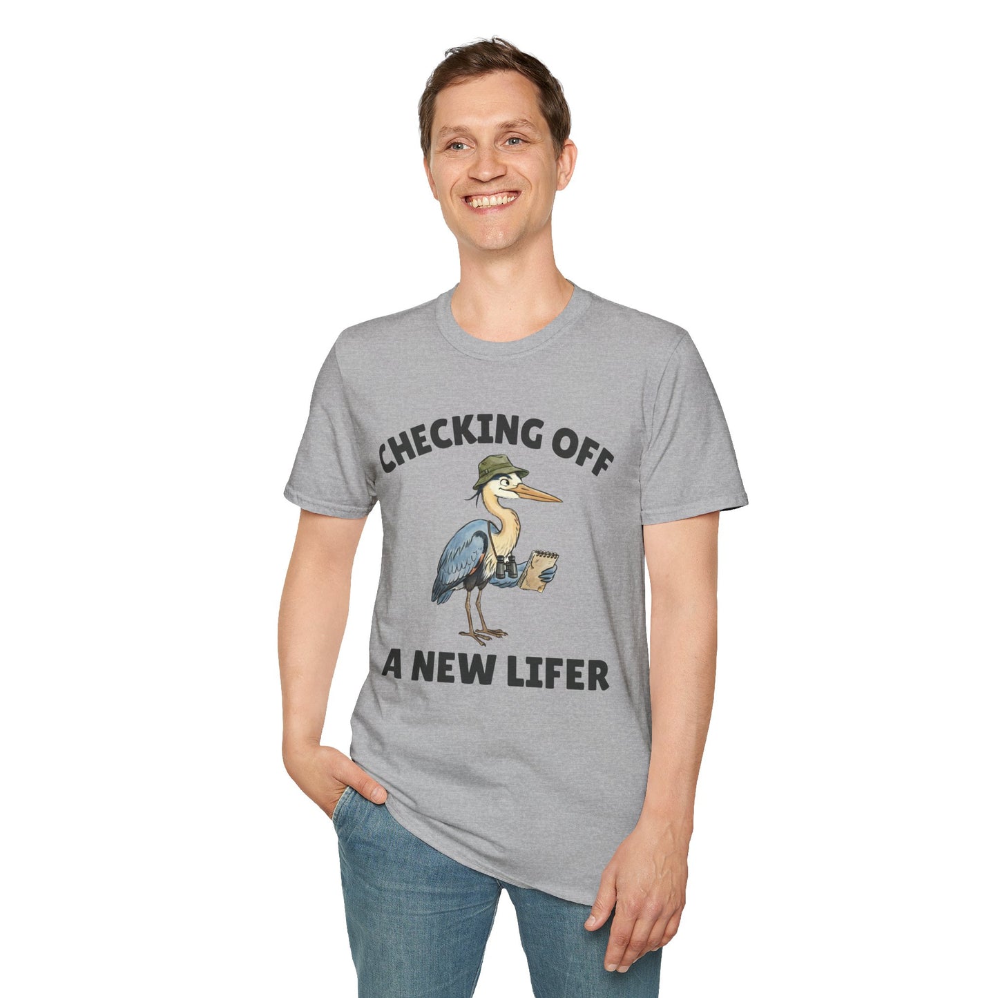 Person wearing gray short-sleeve t-shirt with a graphic of a heron wearing a green hat and holding checklist and binoculars, with the text 'CHECKING OFF A NEW LIFER' with a white blackground.