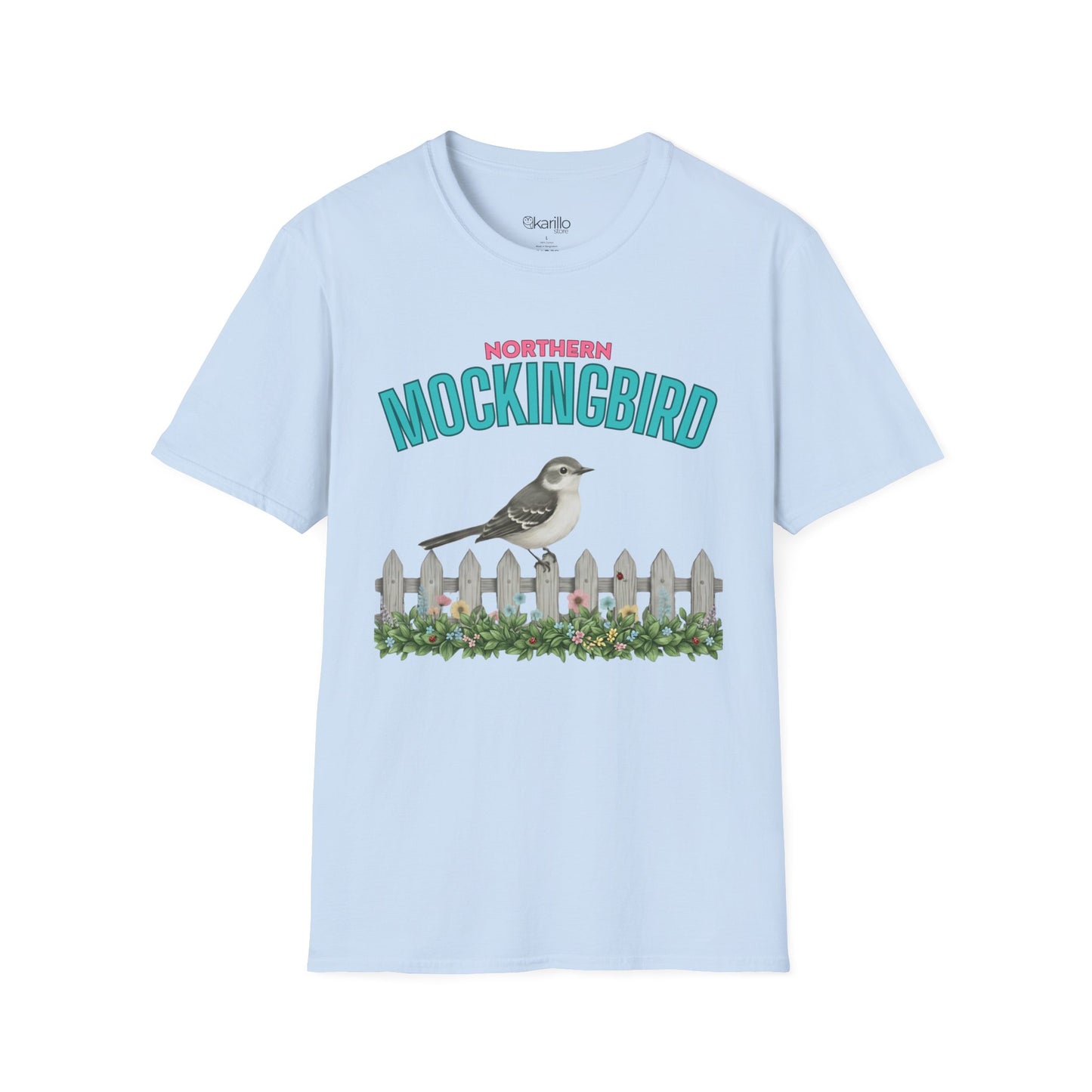 A light blue  t-shirt with a graphic print featuring the text 'NORTHERN MOCKINGBIRD' in teal and pink, an illustration of a mockingbird perched on a white picket fence with green foliage, with white background.