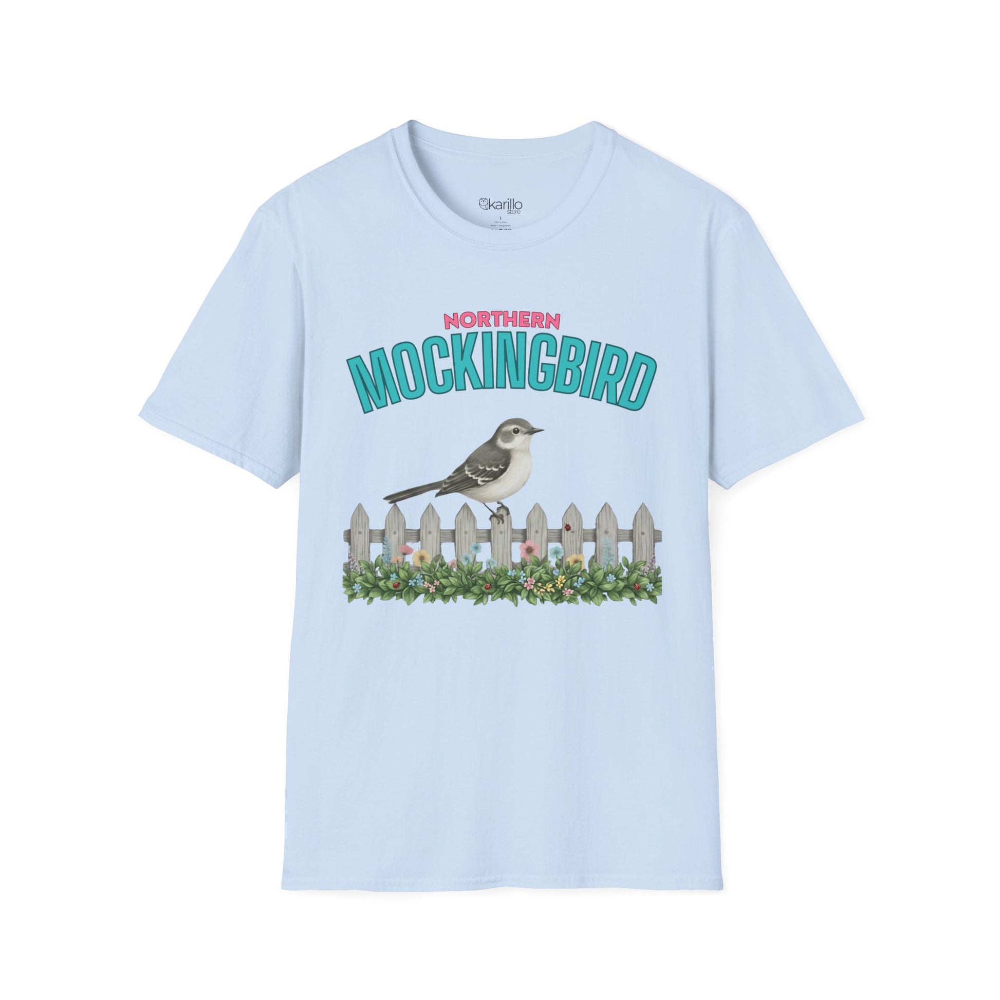 A light blue  t-shirt with a graphic print featuring the text 'NORTHERN MOCKINGBIRD' in teal and pink, an illustration of a mockingbird perched on a white picket fence with green foliage, with white background.