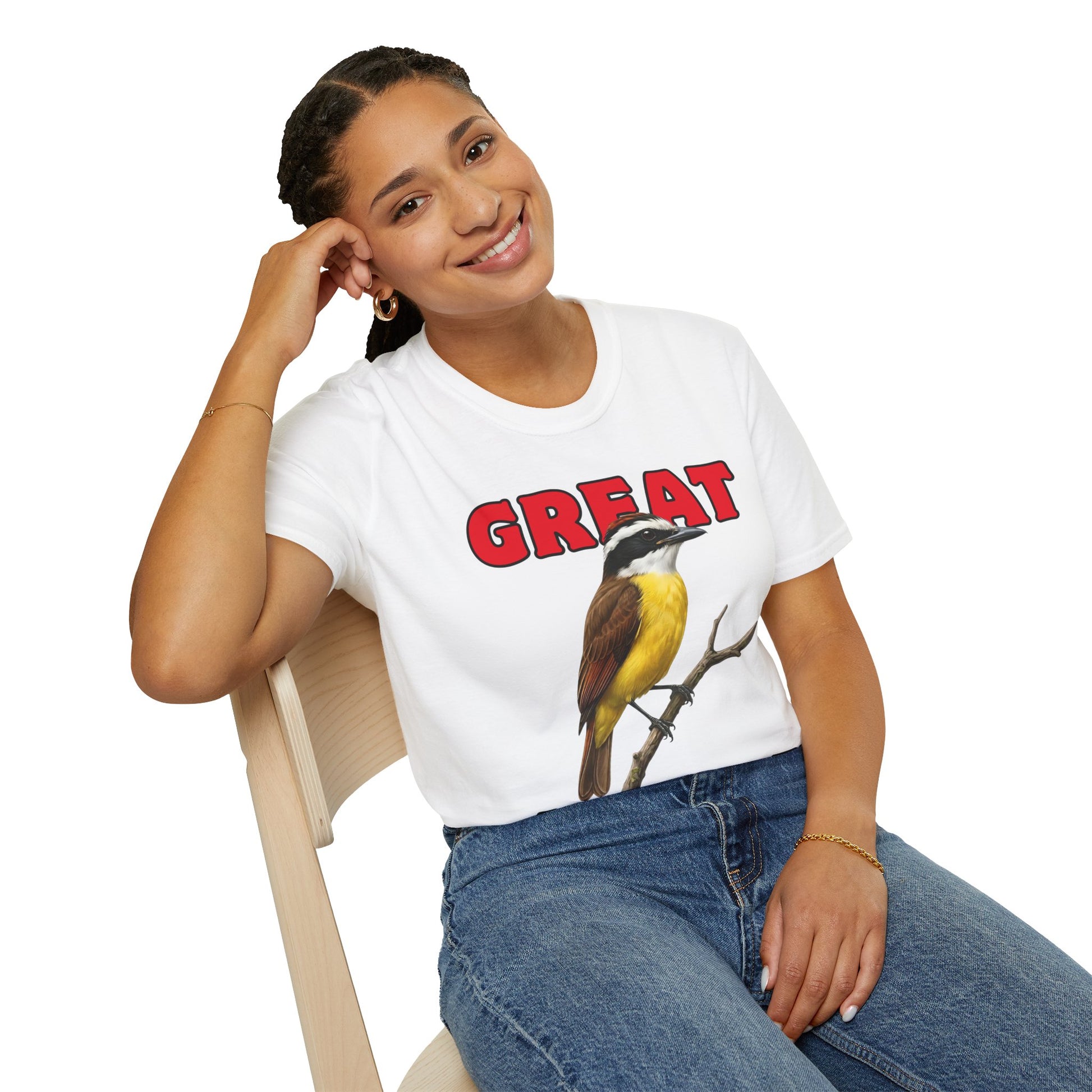 Person wearing a white t-shirt with a bird graphic and 'GREAT KISKADEE' text, sitting on a chair.