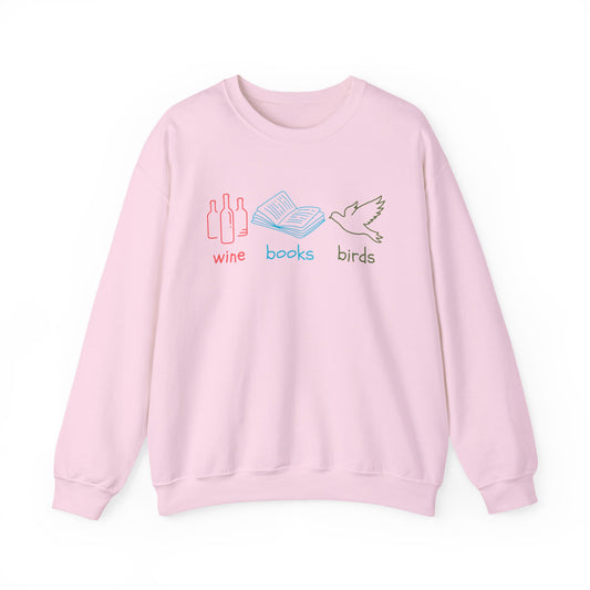 Pink sweatshirt with 'wine', 'books', and 'birds' graphics on a white background