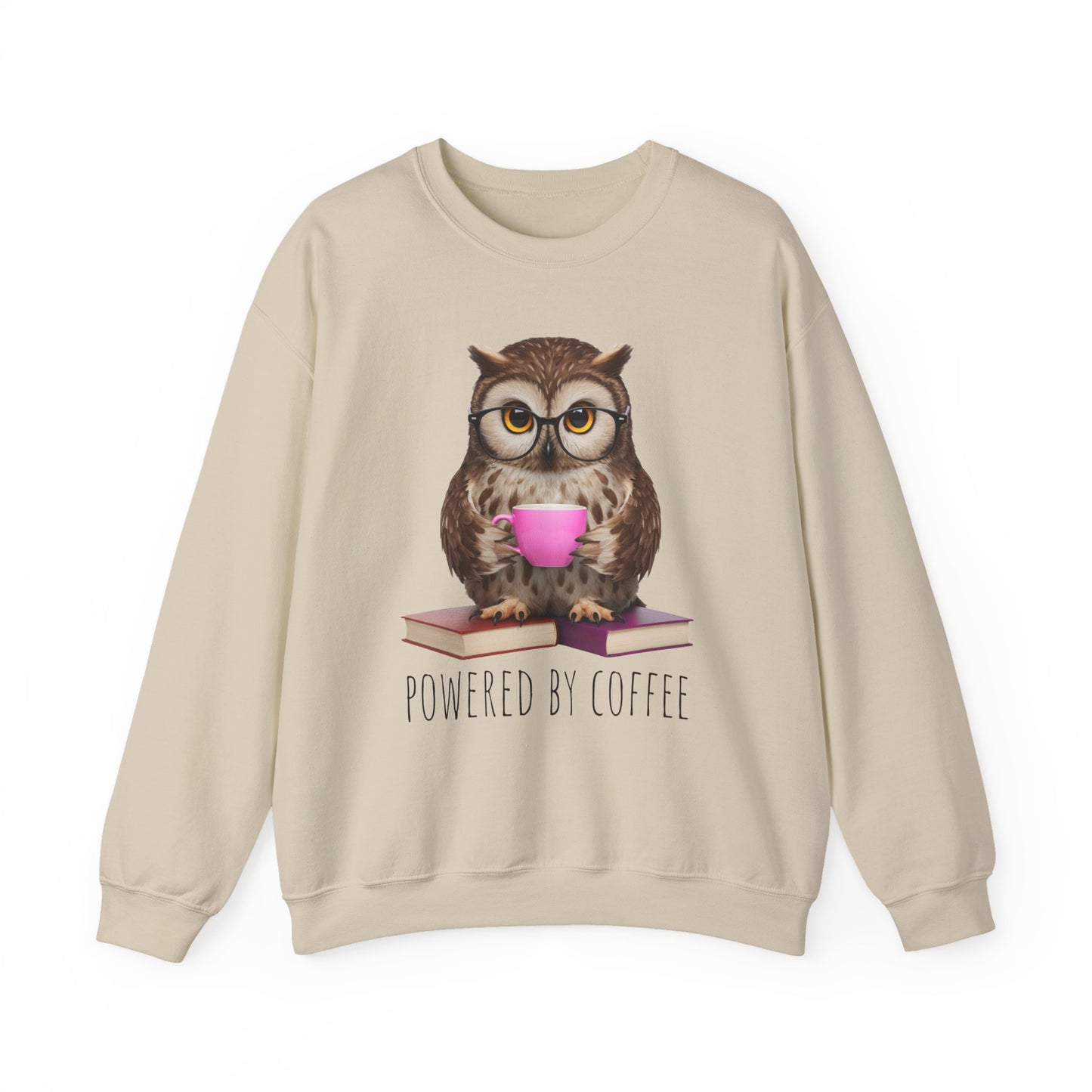 Beige sweatshirt with an owl graphic holding a pink cup and books, with 'Powered by Coffee' text.