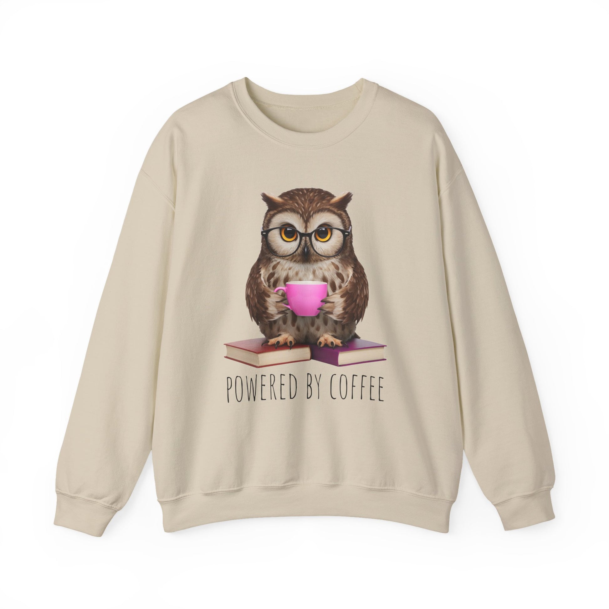 Beige sweatshirt with an owl graphic holding a pink cup and books, with 'Powered by Coffee' text.