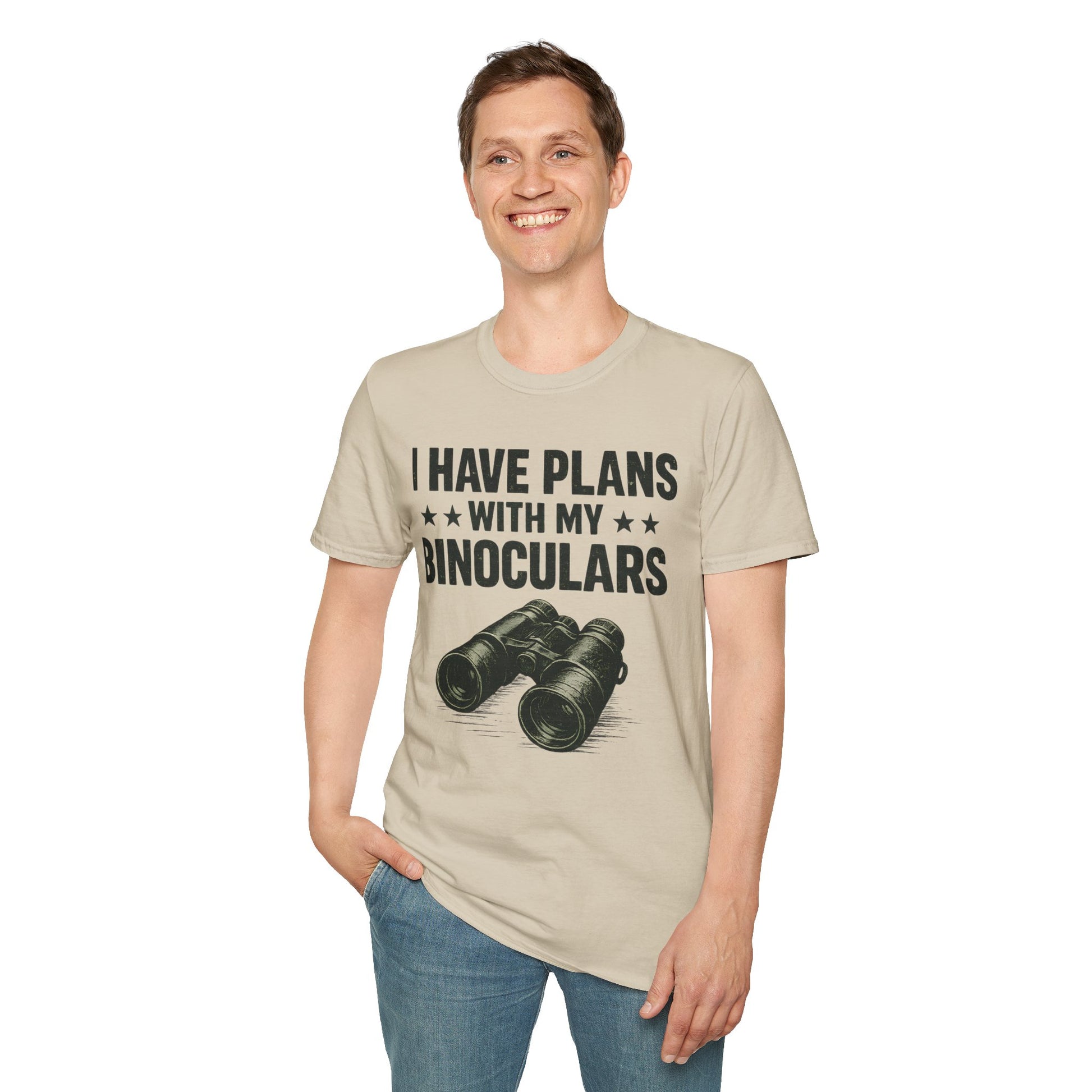 Person wearing beige t-shirt with binoculars graphic and text on a white background