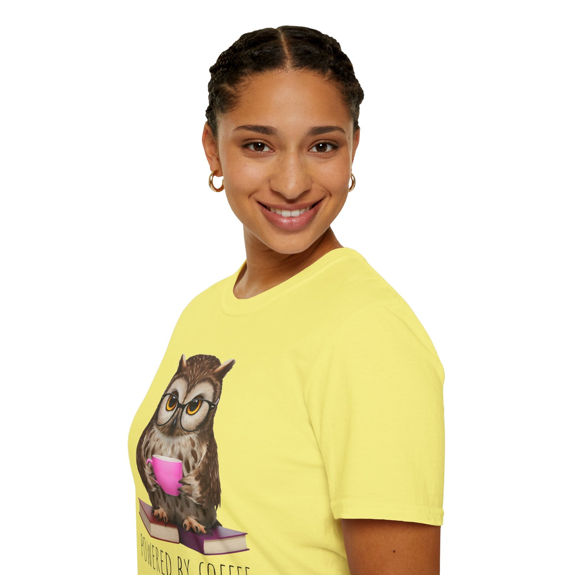 Person wearing a yellow t-shirt with an owl graphic and text on a white background