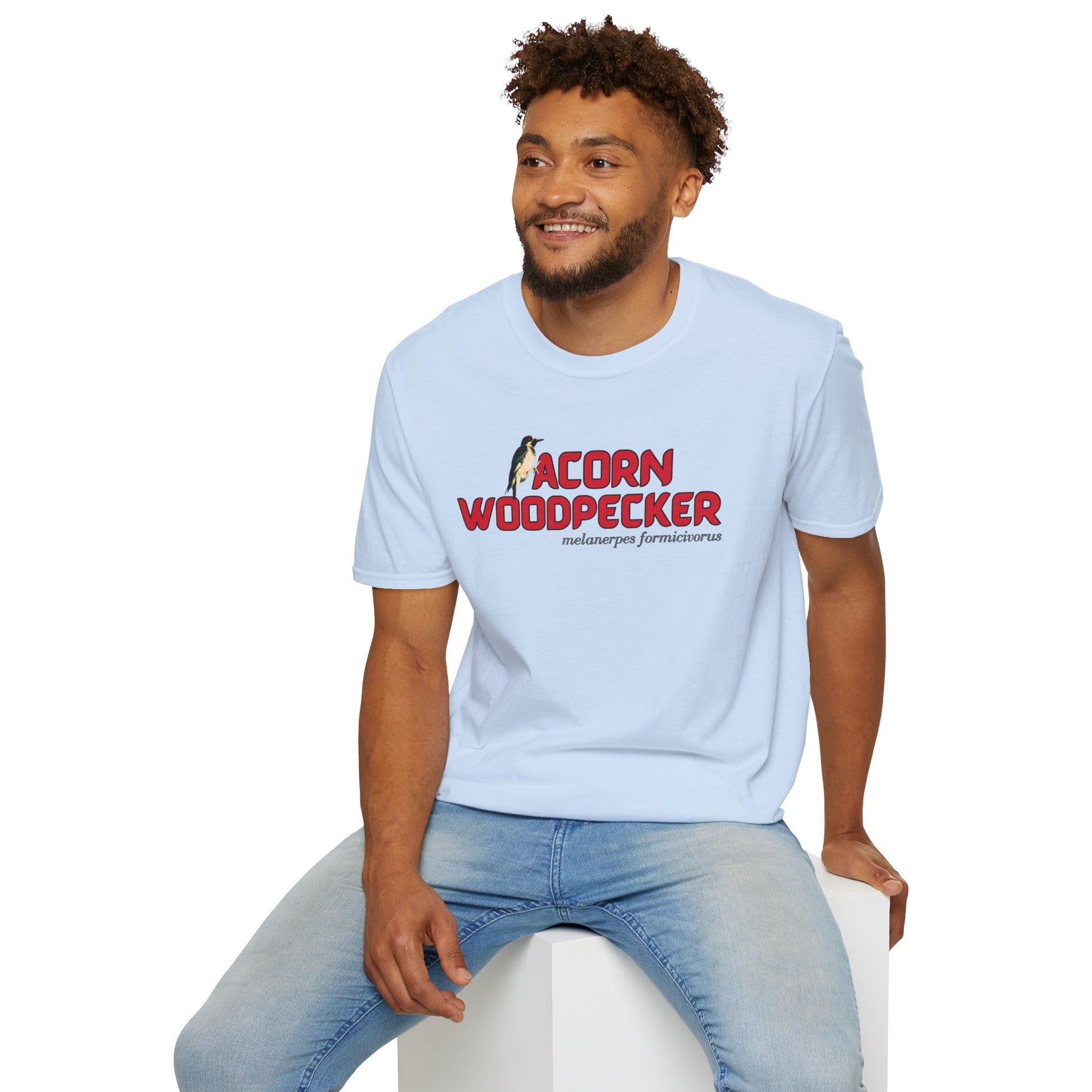man wearing light blue t-shirt with 'acorn woodpecker' text on a white background