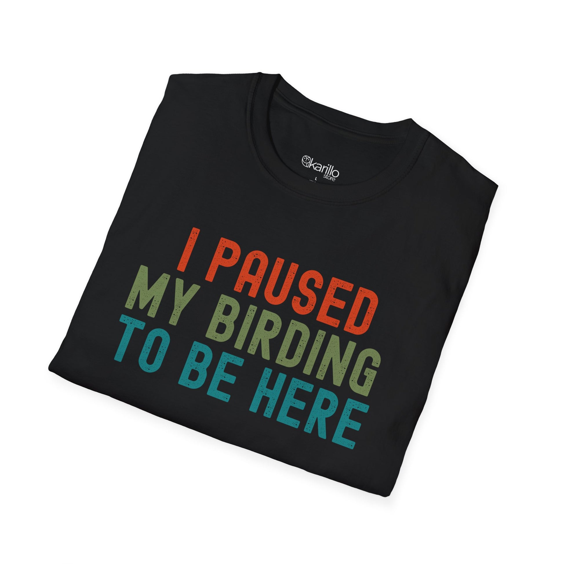 Folded view of Black t-shirt with colorful text 'I PAUSED MY BIRDING TO BE HERE' on a white background