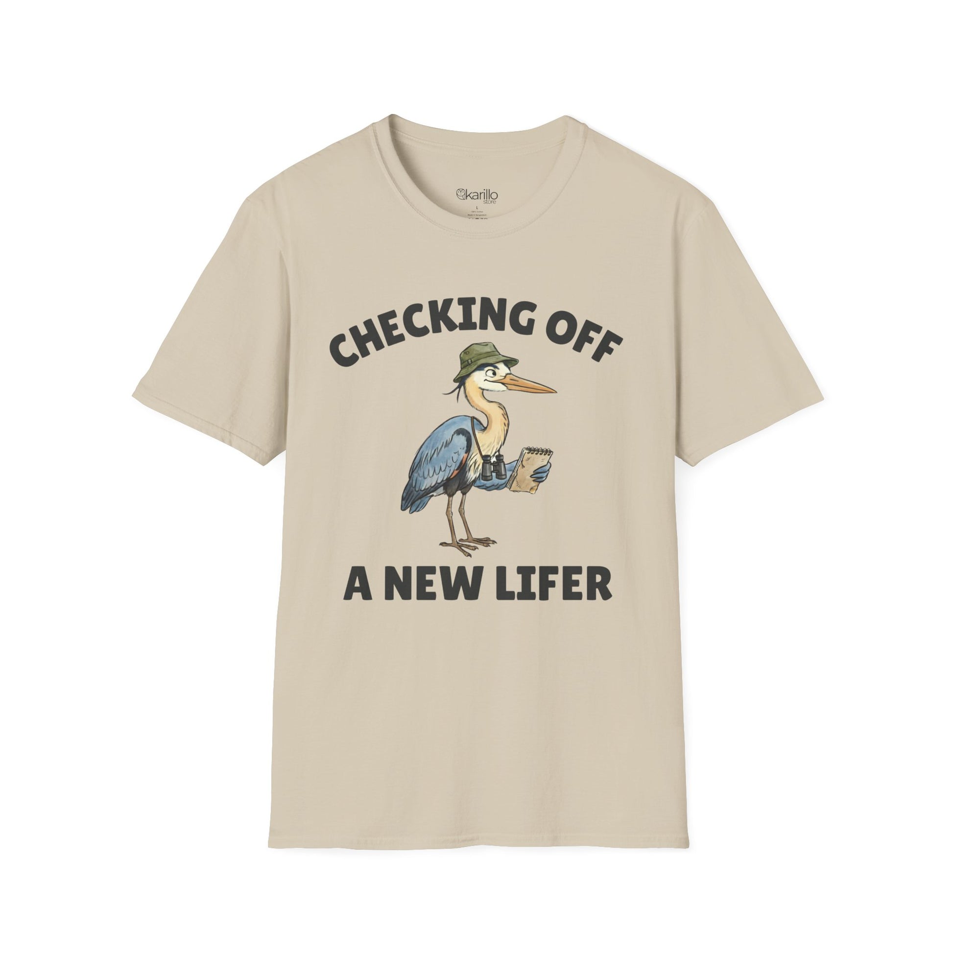 Sand color short-sleeve t-shirt with a graphic of a heron wearing a green hat and holding checklist and binoculars, with the text 'CHECKING OFF A NEW LIFER' with a white blackground.