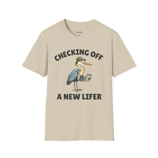 Sand color short-sleeve t-shirt with a graphic of a heron wearing a green hat and holding checklist and binoculars, with the text 'CHECKING OFF A NEW LIFER' with a white blackground.