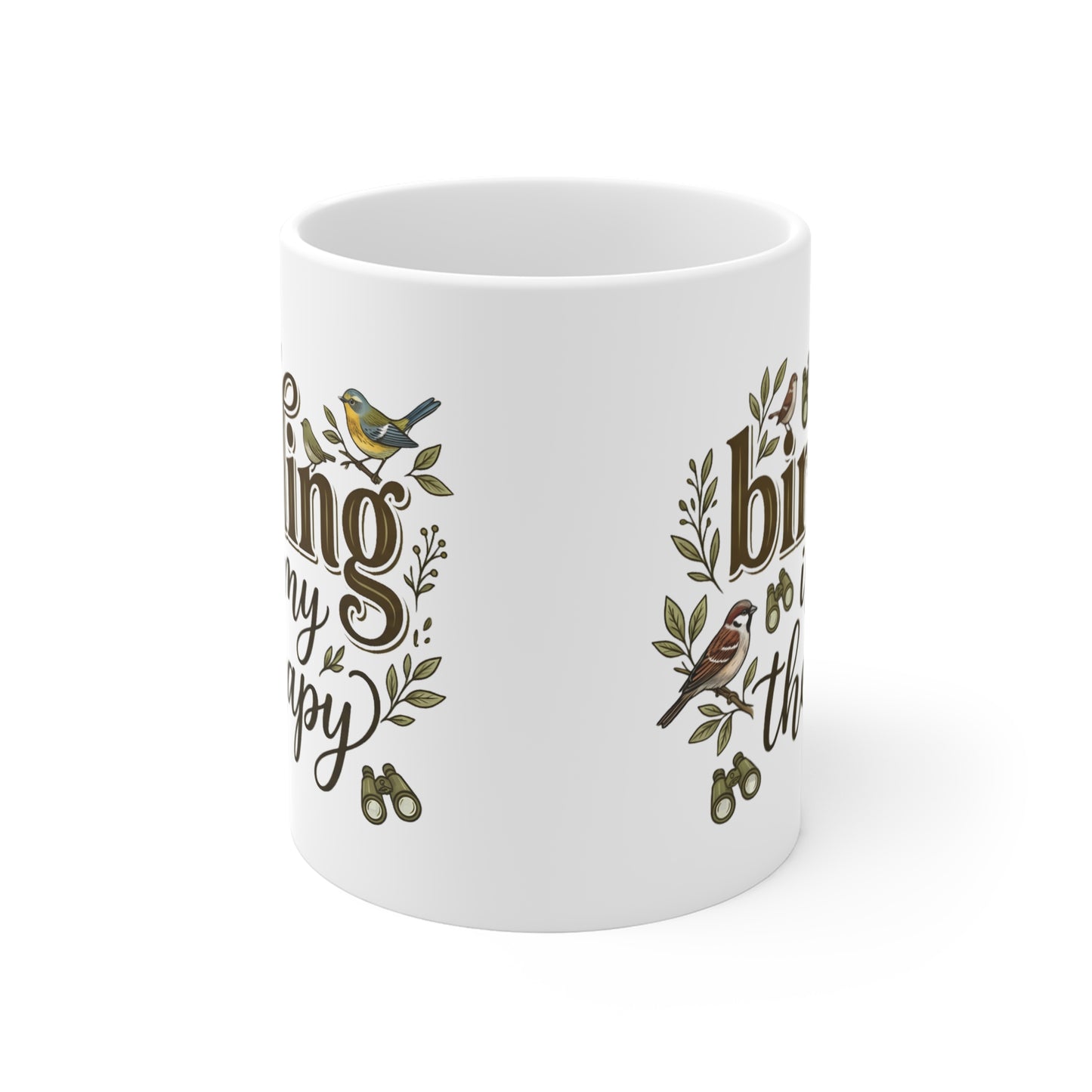 A white ceramic mug featuring a printed design with brown cursive text, green leaves, and small birds, shown on a clean white background.