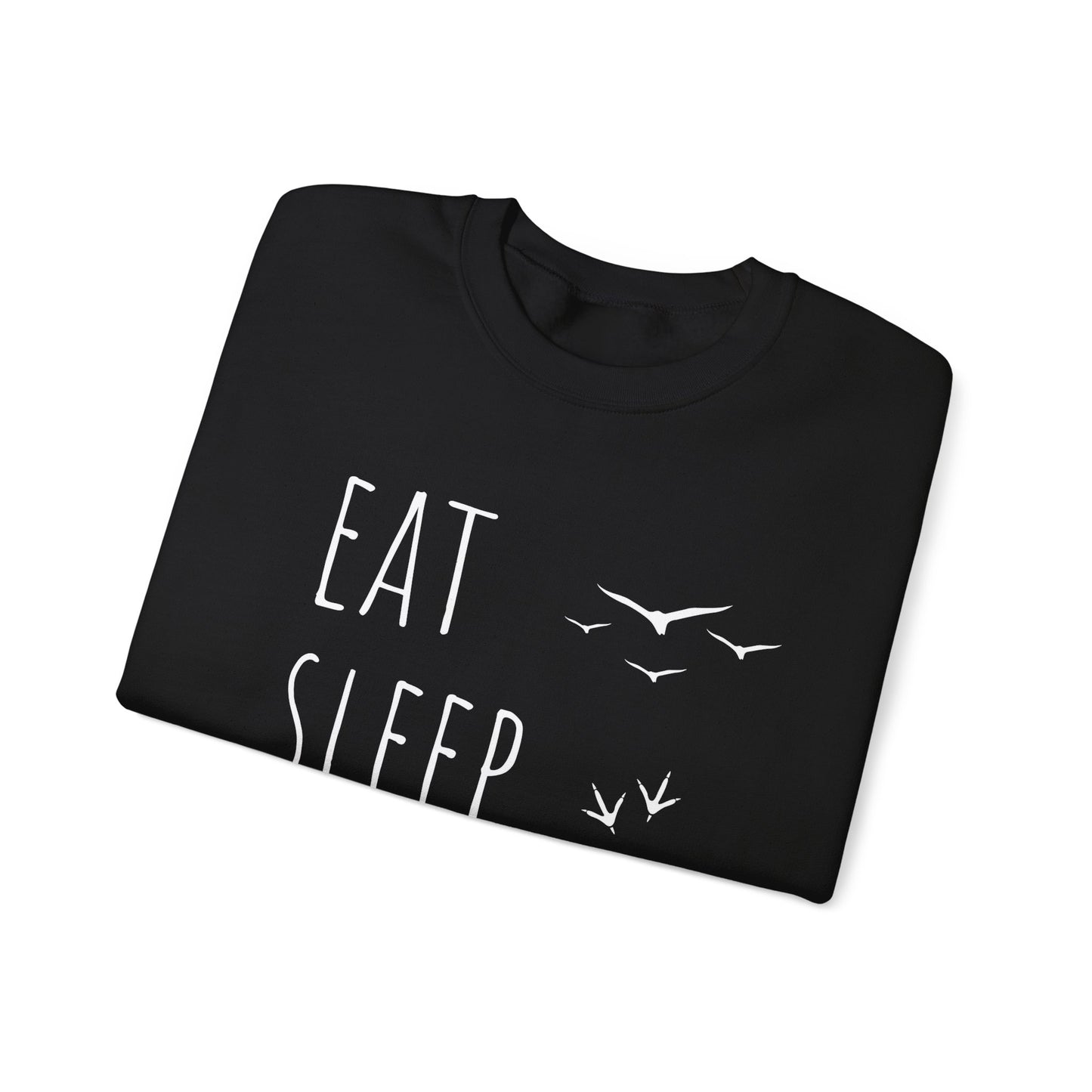 Folded black t-shirt with 'EAT SLEEP' text and bird illustrations on a white background