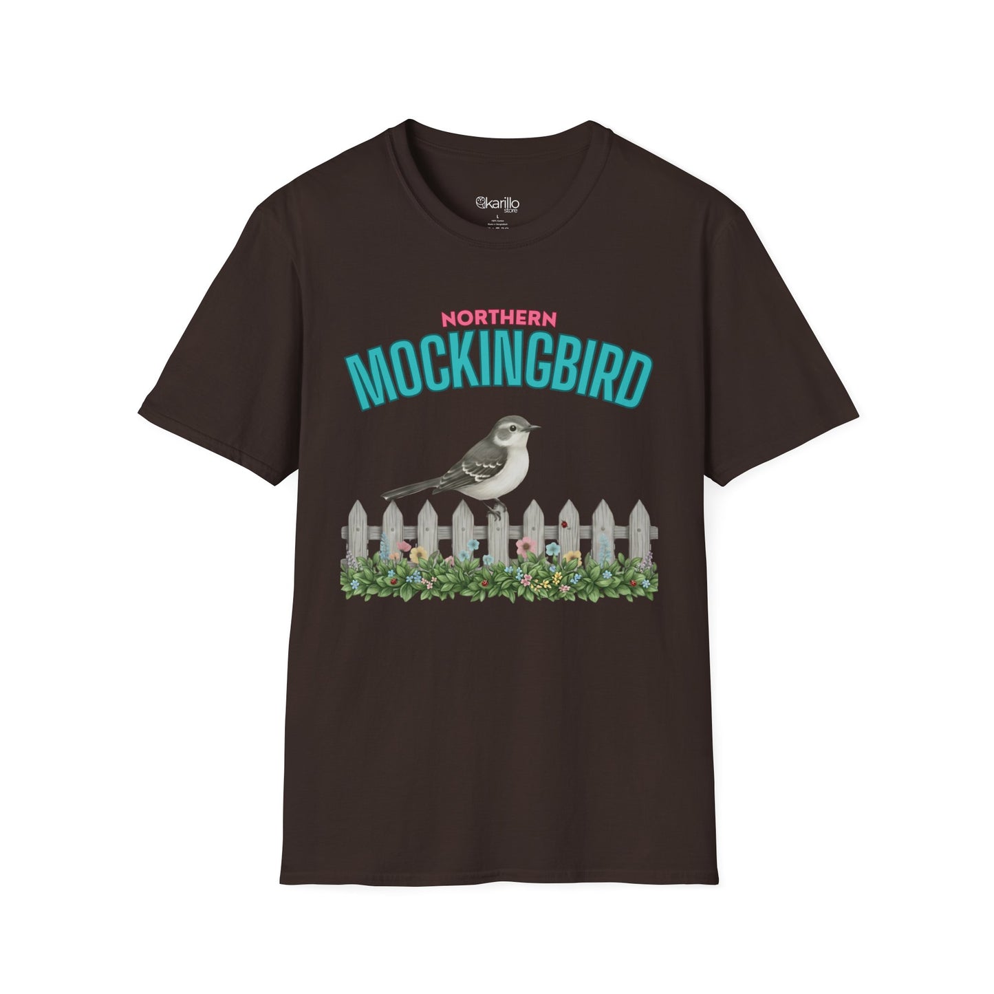A brown t-shirt with a graphic print featuring the text 'NORTHERN MOCKINGBIRD' in teal and pink, an illustration of a mockingbird perched on a white picket fence with green foliage, with white background.
