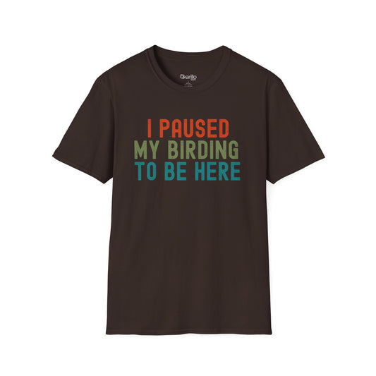 Front view of brown t-shirt with colorful text 'I PAUSED MY BIRDING TO BE HERE' on a white background