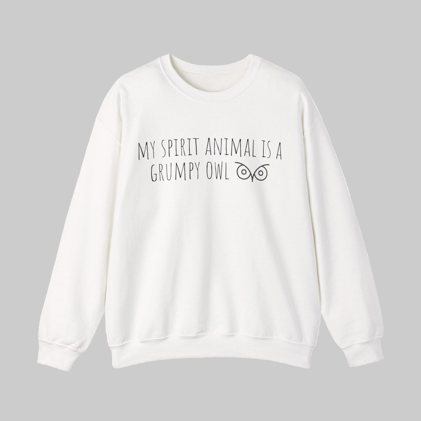 White sweatshirt with text 'My Spirit Animal is a Grumpy Owl' on a light gray background