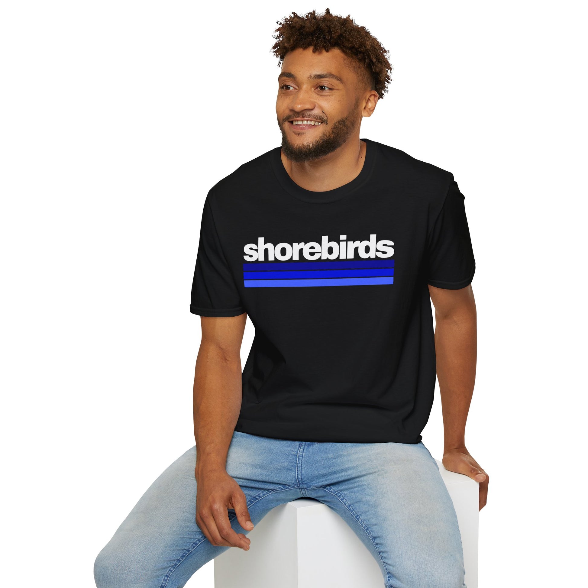 Man wearing black t-shirt with 'shorebirds' text and blue stripes on a white background